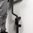 Specialty barbell stored vertically on the PRx wall mount in a home gym