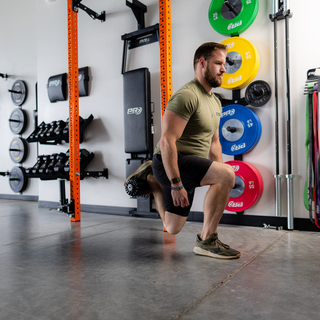 Athlete performing a Nordic curl using the PRx Leg Roller Attachment
