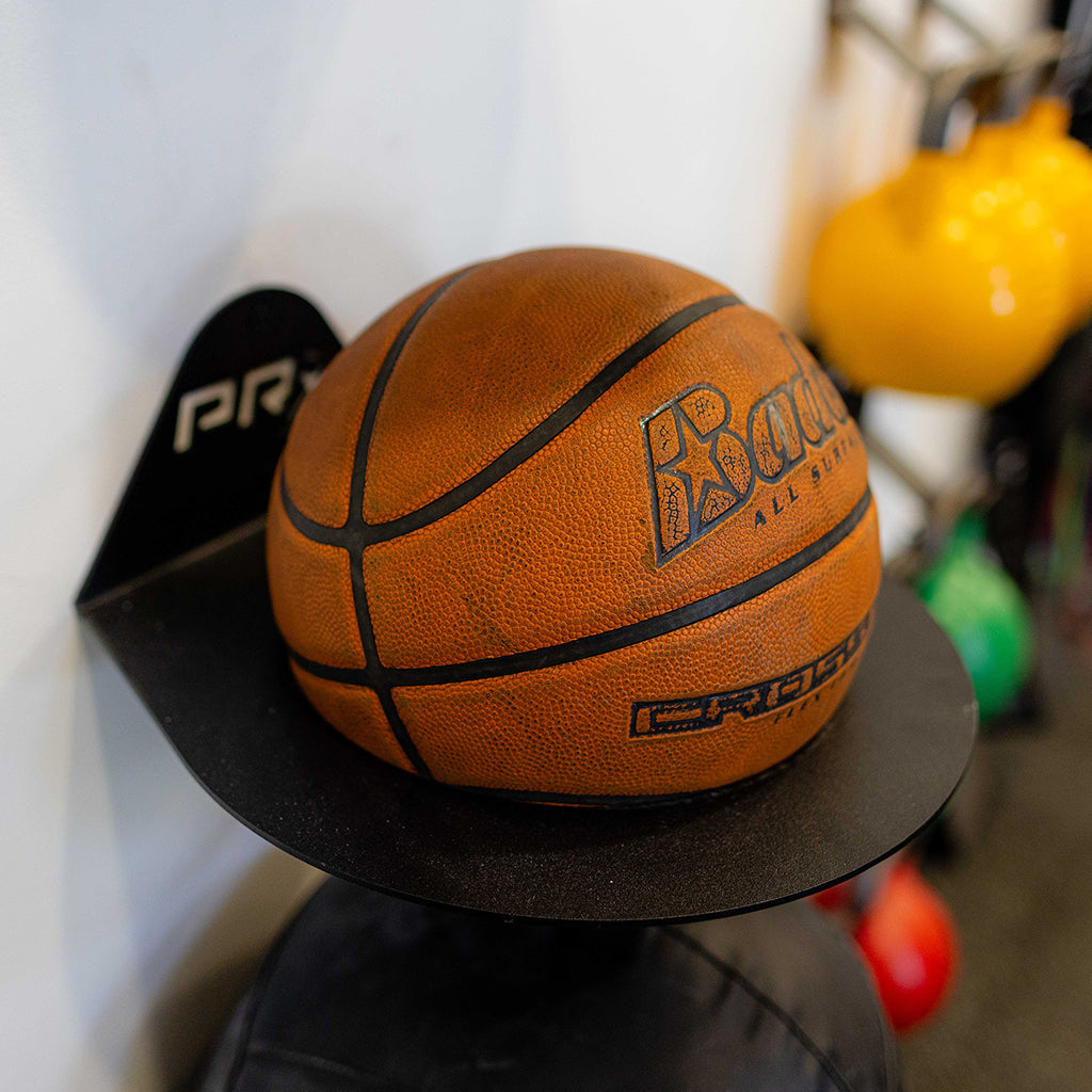 PRx ball storage mounted on a garage wall with a basketball
