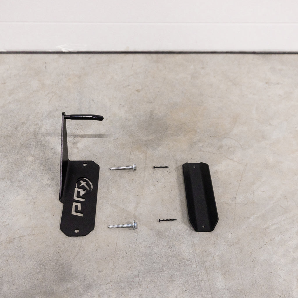 Rider lifting a bike onto the PRx Single Bike Storage wall hook