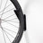Bike hanging vertically on the PRx Single Bike Storage in a home garage gym