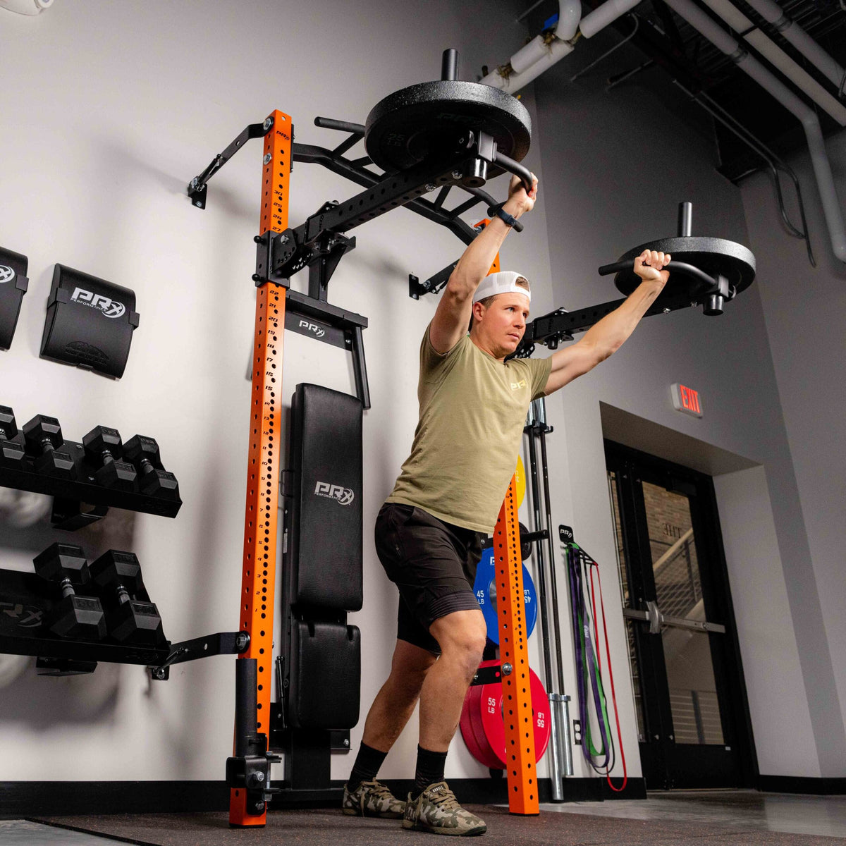 Athlete pressing with PRx Profile Halo Arms in a home gym