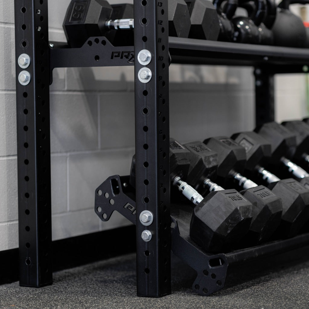 Flat shelf plates holding dumbbells on the PRx Build Limitless storage unit