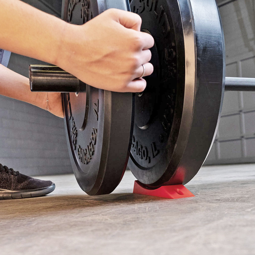 Body Solid Olympic Plate Wedge - loading a plate