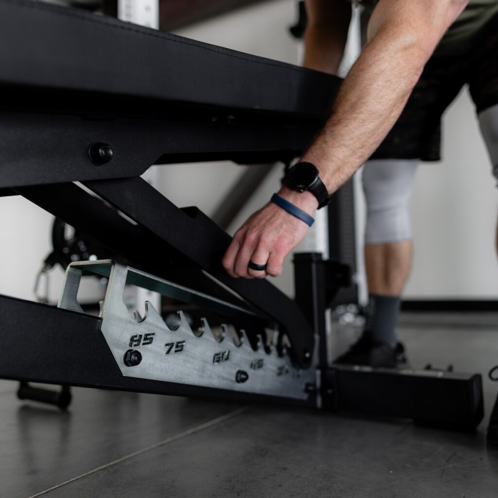 PRx Razortooth Weight Bench stored vertically against a wall