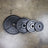 PRx cast iron Olympic plates stacked in a home gym