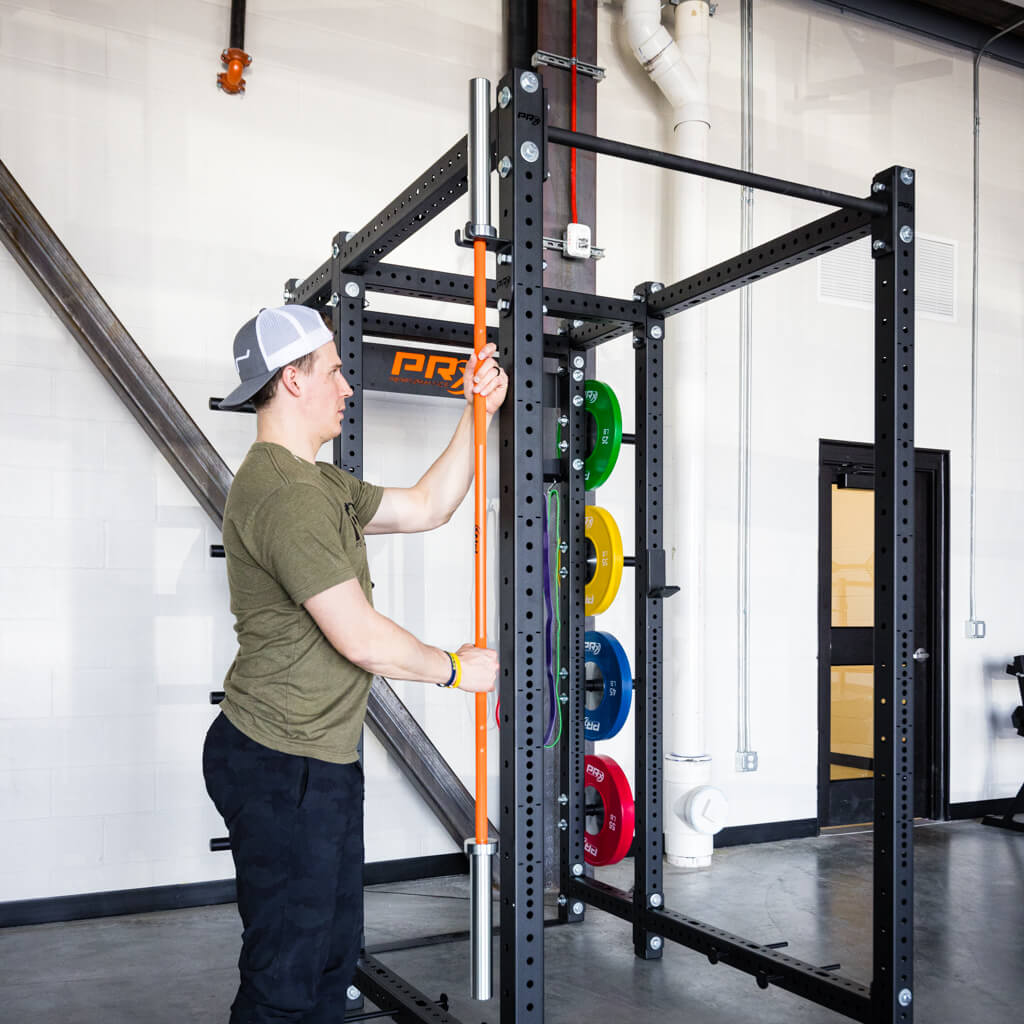PRx Build Limitless barbell hanger shown in a home gym rack setup