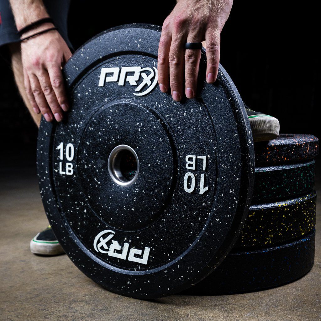 PRx Color Fleck Bumper Plates stored on a wall mounted plate rack