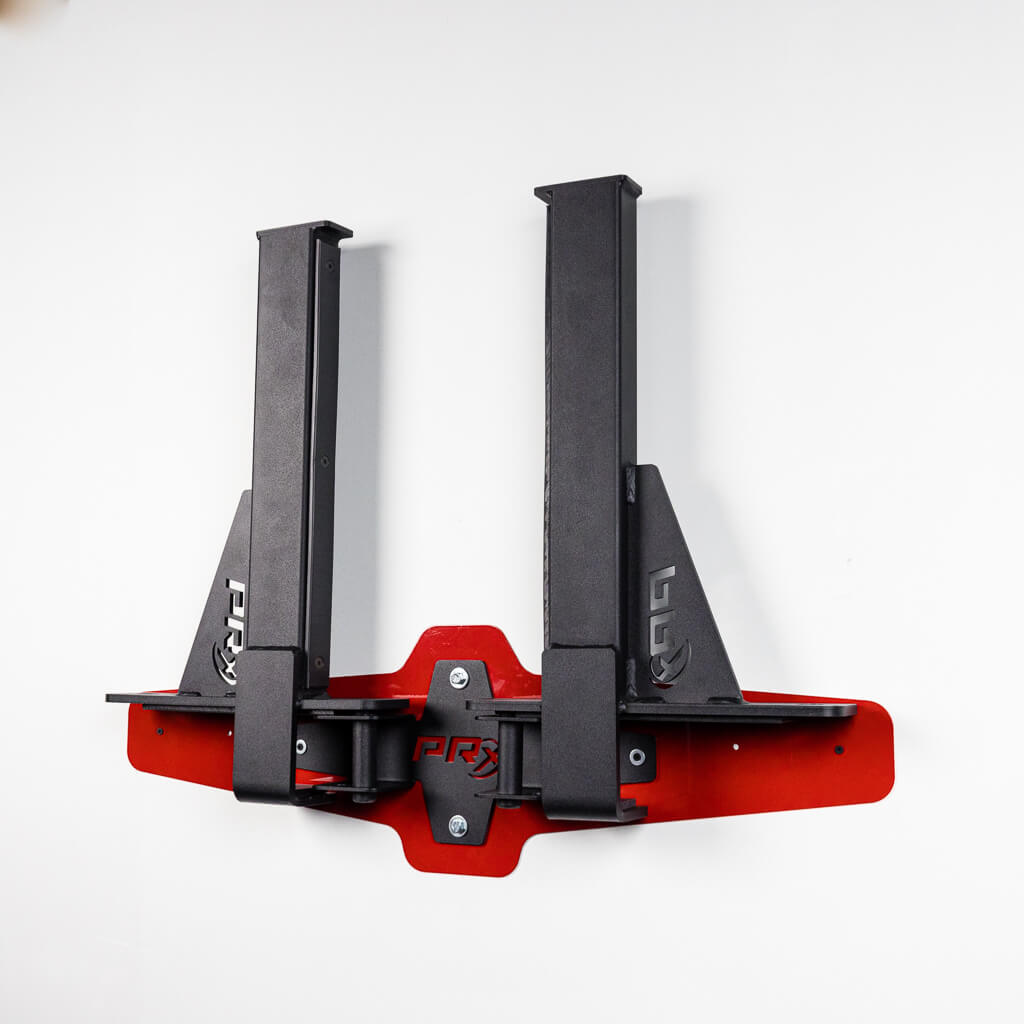 Spotter arms sliding into the PRx wall storage cradle