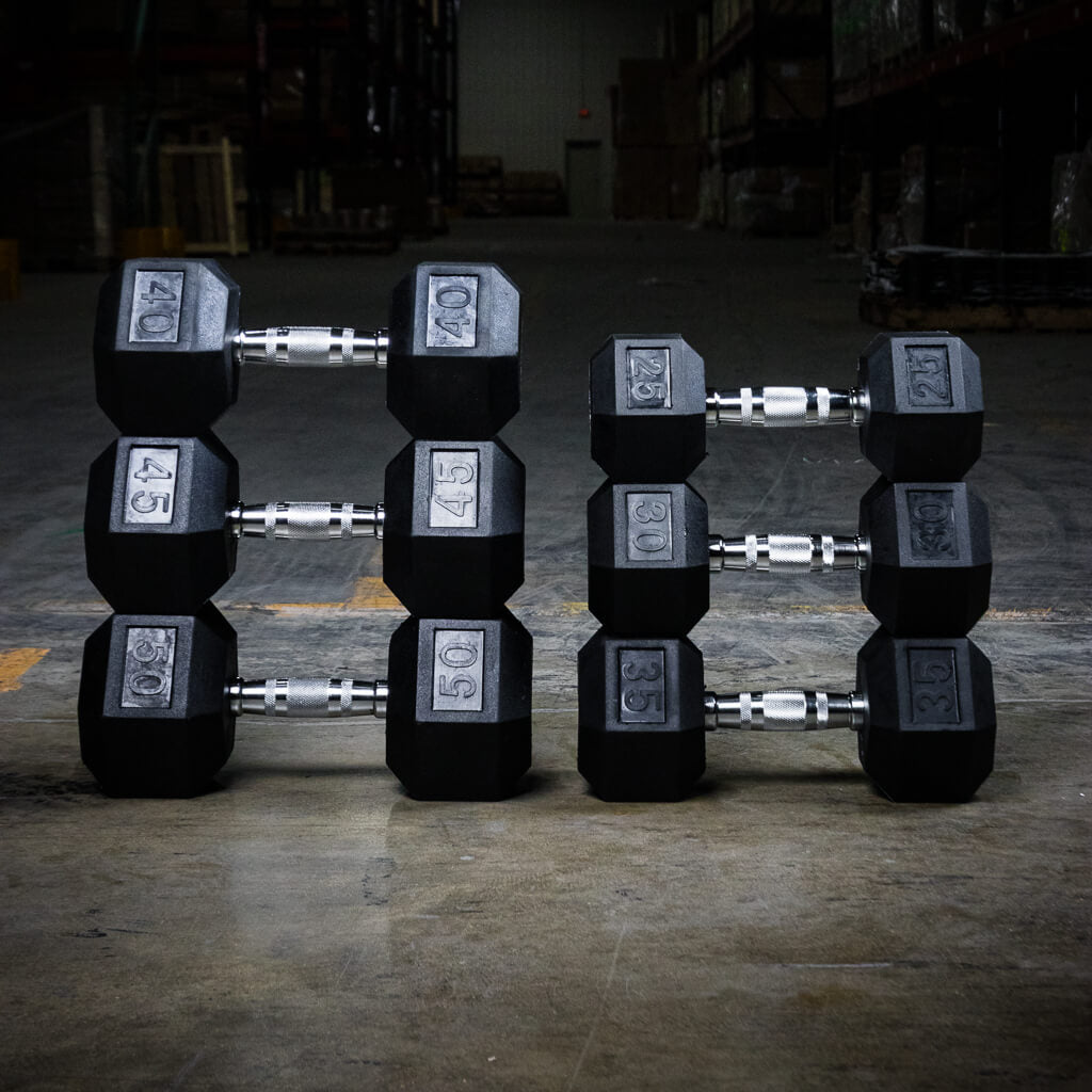 PRx rubber hex dumbbells resting on a gym floor