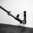 Barbell stored upright in the PRx Landmine / Bar Storage against a gym wall