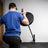 PRx wall-mounted landmine pivoting with a barbell during a rowing movement