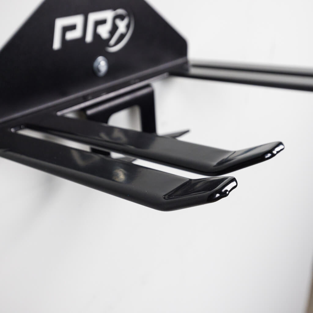 Snowboards resting on the rubber-dipped pegs of the PRx Ski and Snowboard Storage