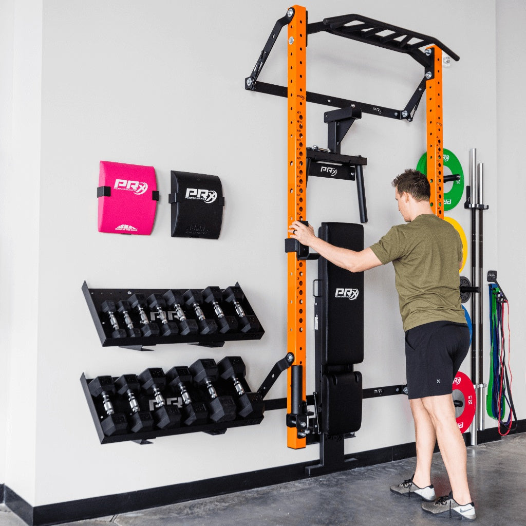 Two PRx dumbbell storage shelves nested side by side on a garage wall